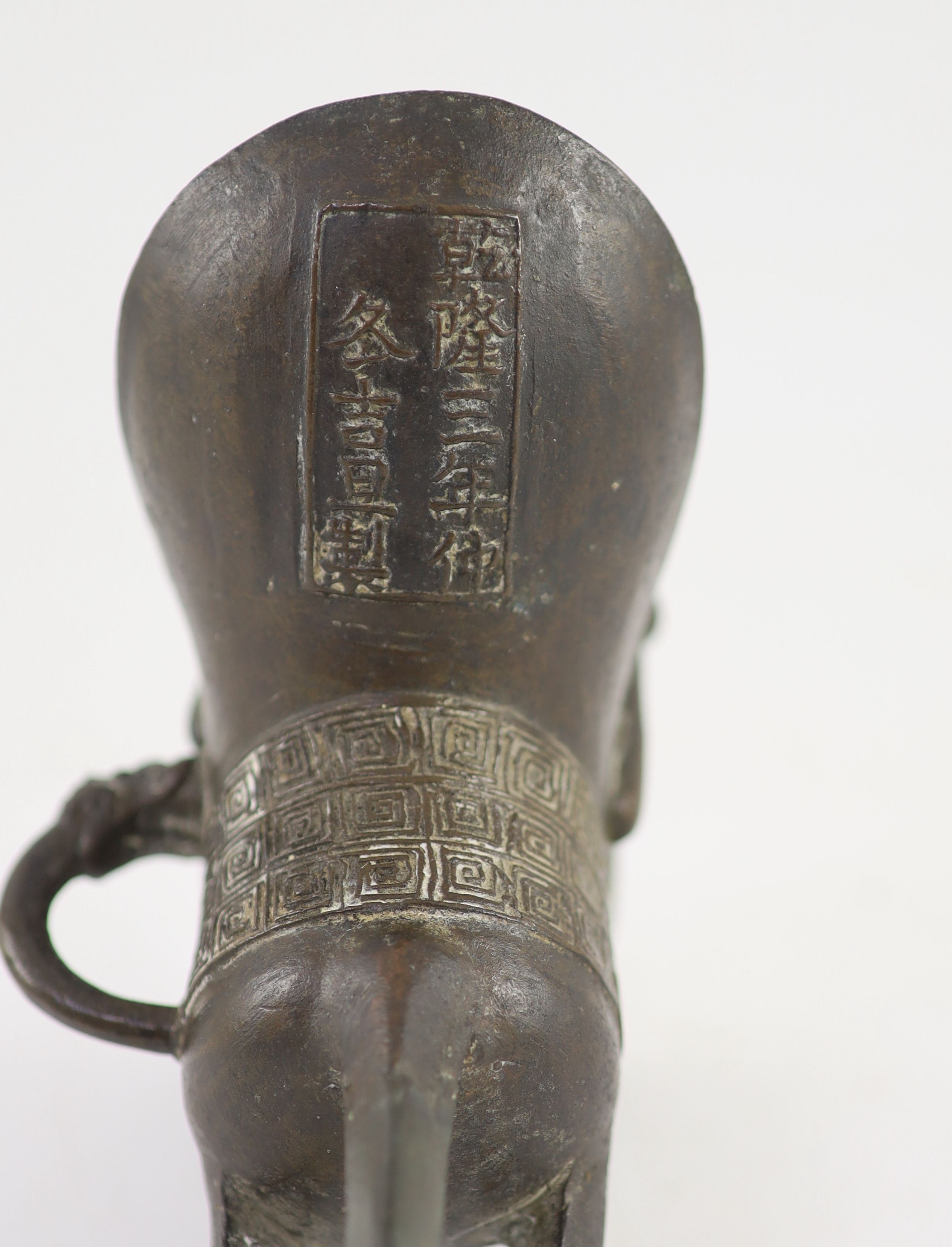 A Chinese archaistic bronze ritual tripod wine vessel, jue, Qianlong cyclical date mark and period, 16 cm high